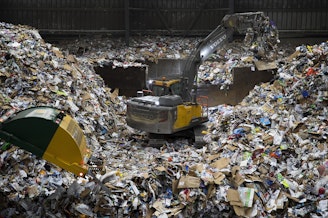 caption: A large pile of recyclables forms where arriving trucks dump the materials before they are sorted on Friday, October 26, 2018, at Cascade Recycling Center in Woodinville.